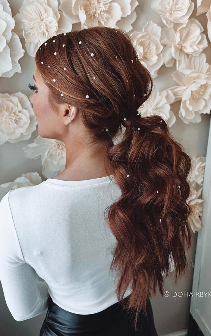 romantic low bridal ponytails with scattered pearls